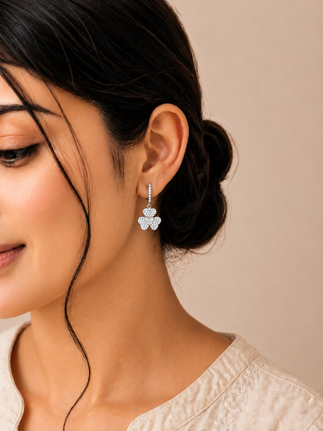 Close-up of a woman wearing a floral earring against a neutral background