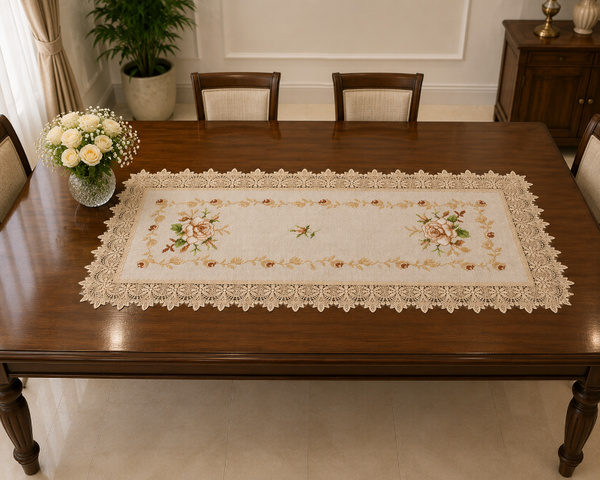 An embroidered table runner with a floral pattern and scalloped lace border, displayed on a dark wood dining table in a dining room setting.
