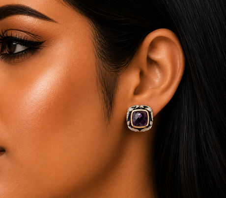 Close-up of a woman's ear wearing a decorative earring with a purple gemstone.