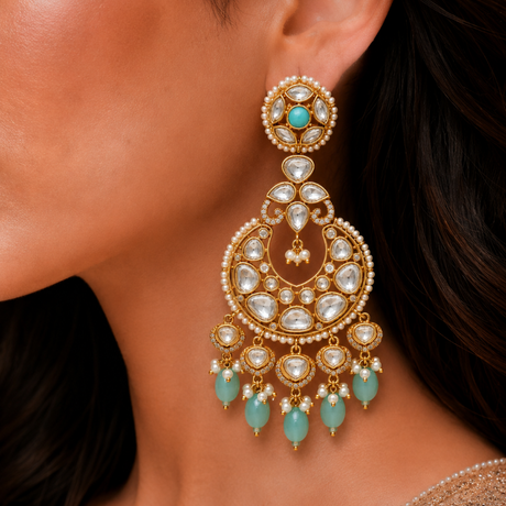 Close-up of a woman wearing a gold and turquoise earring.