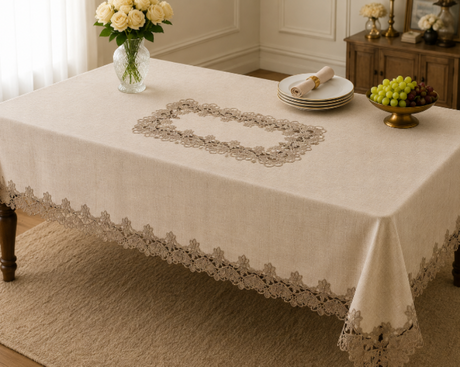 Table set with lace tablecloth, plates, and decorative items in a room.