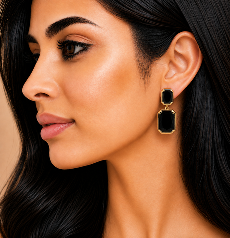 Close-up of a woman wearing a black earring with gold accents.