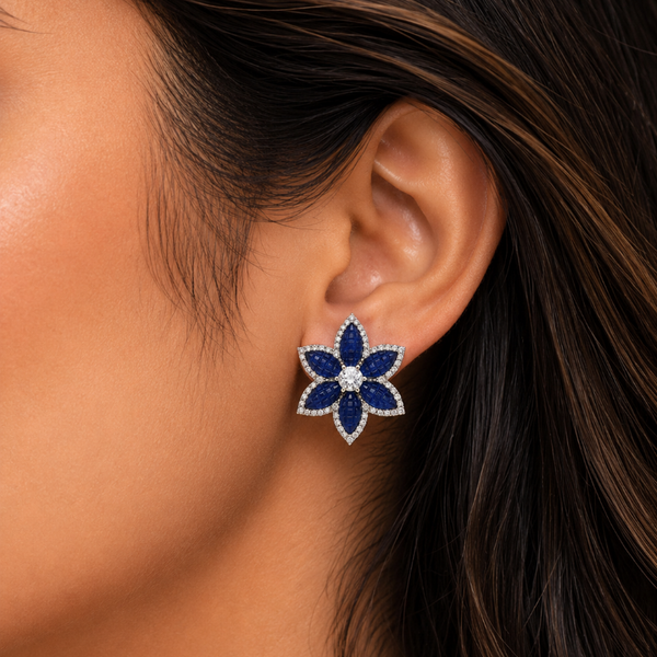 Close-up of a woman wearing a blue floral earring.