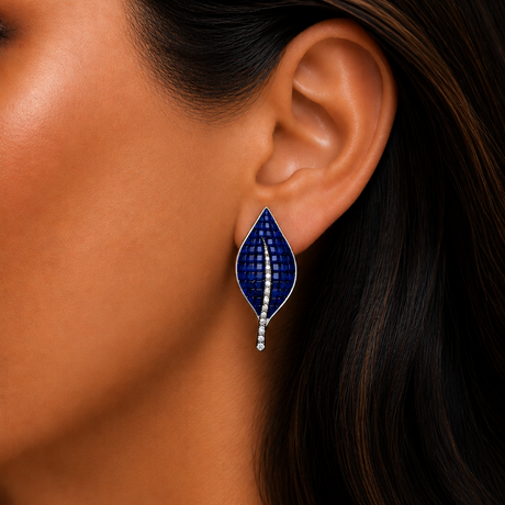 Close-up of a woman wearing a blue and silver earring.