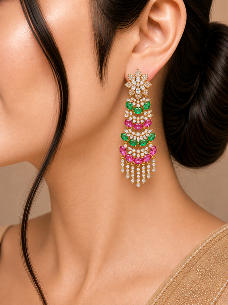 Close-up of a woman wearing a colorful earring with green, pink, and gold elements.