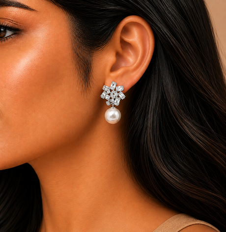Close-up of a woman wearing a snowflake-shaped earring with a pearl center.
