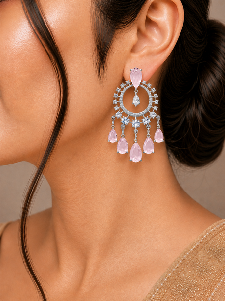 Close-up of a woman wearing a sparkling earring with pink and blue gemstones.