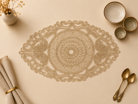 Decorative doily on a beige surface with gold cutlery and small bowls.