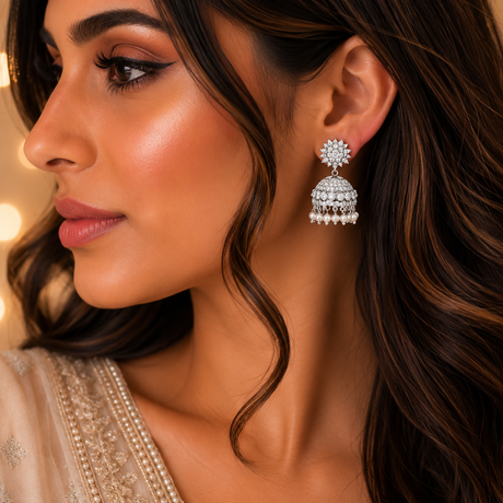 Close-up of a woman wearing a silver earring with a blurred background
