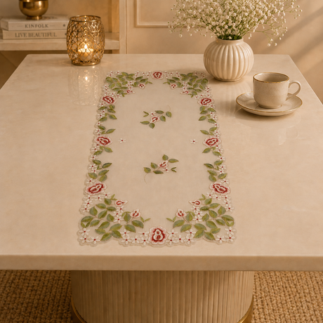 Decorative table runner with floral pattern on a table with a cup and saucer.