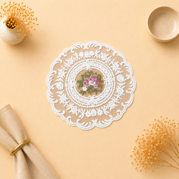 Lace doily with floral design on a beige surface with decorative elements.