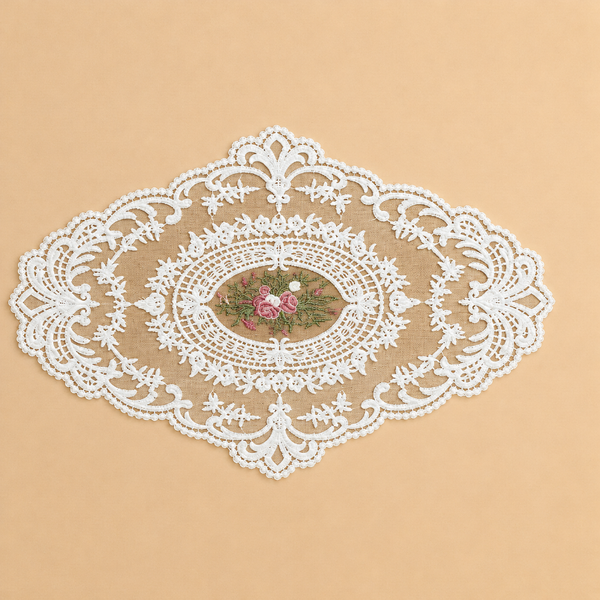 Decorative white lace doily with floral design on a beige background