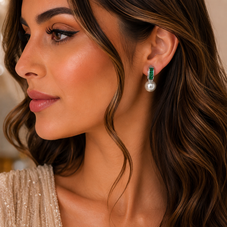 Close-up of a woman wearing elegant earrings with a neutral background