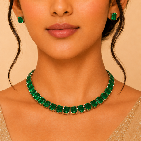 Woman wearing a green emerald necklace and earrings on a beige background