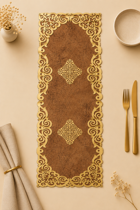 Decorative gold placemat with intricate patterns on a beige surface with cutlery and paper.