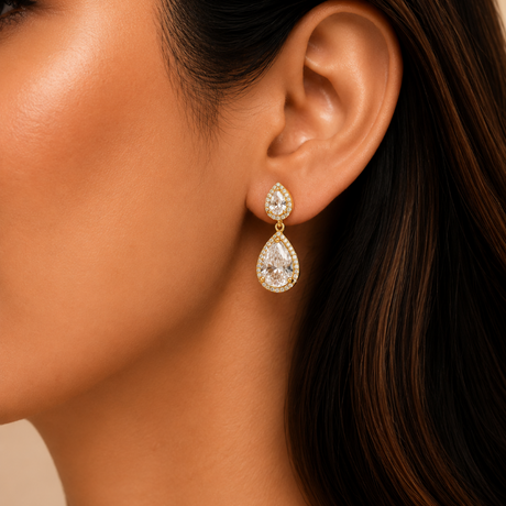 Close-up of a woman wearing a gold and diamond earring.