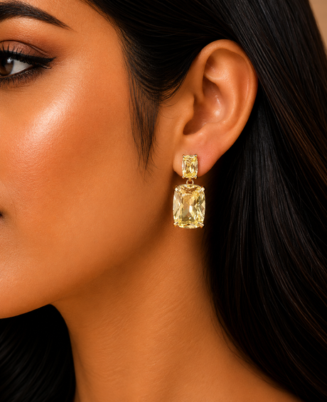 Close-up of a woman wearing a gold earring with a large gemstone.