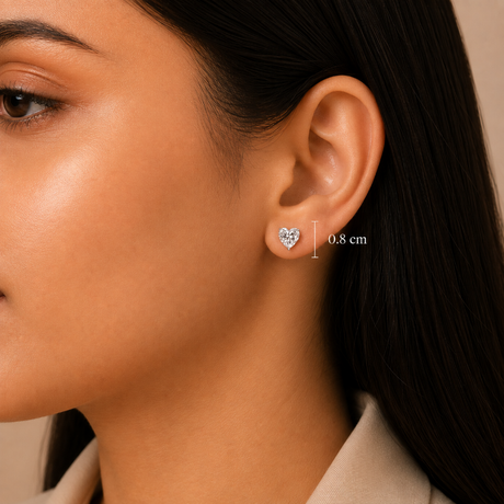 Close-up of a woman's ear wearing a small heart-shaped stud earring, with a measurement marker indicating 0.8 cm height.
