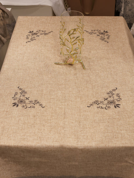 Beige tablecloth with floral patterns on a dining table