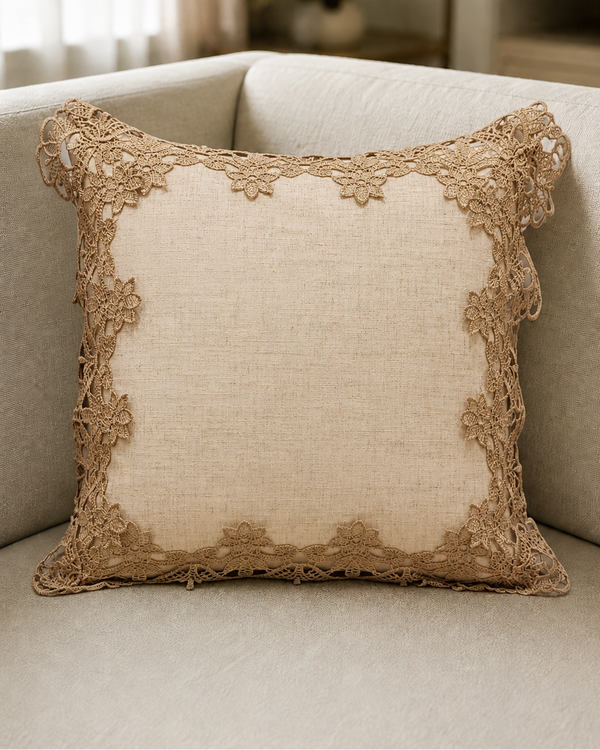 Decorative pillow with lace trim on a beige sofa in a living room setting.