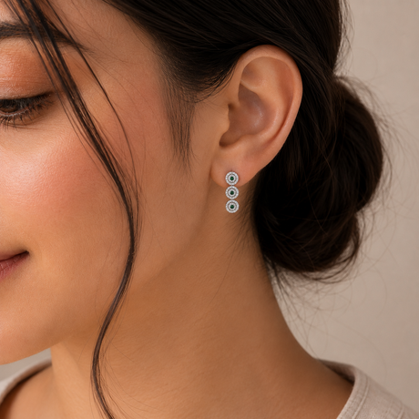 Close-up of a woman wearing earrings with a neutral background