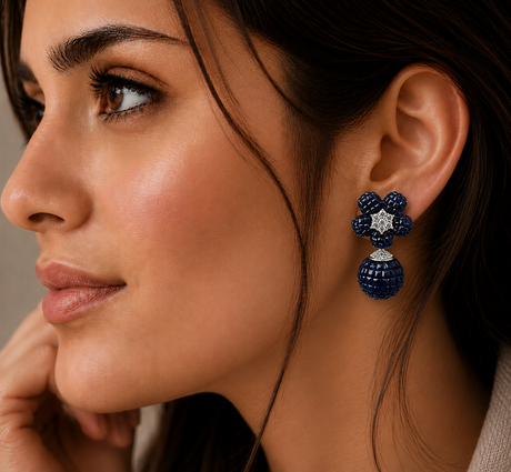 Close-up of a woman wearing a blue floral earring with a beige background