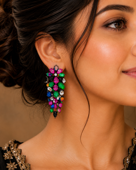 Close-up of a woman wearing colorful earrings with a neutral background