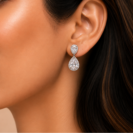 Close-up of a woman wearing a pair of teardrop-shaped earrings.