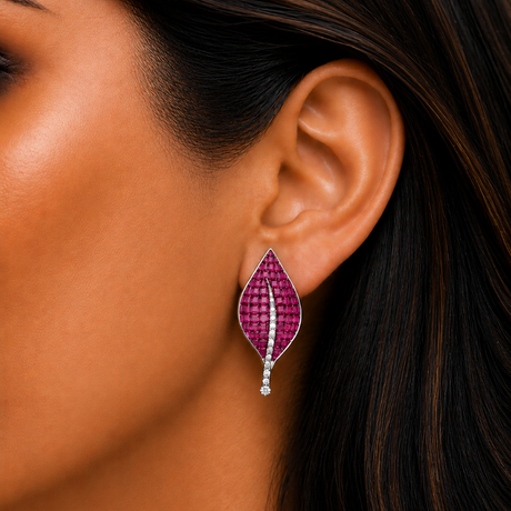 Close-up of a woman wearing a purple leaf-shaped earring.