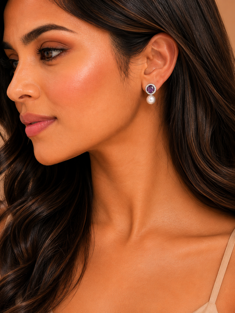 Close-up of a woman wearing earrings with a neutral background