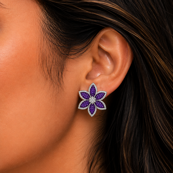 Flower-shaped earring worn by a person with dark hair.