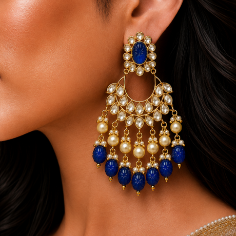 Close-up of a woman wearing a gold earring with blue and pearl beads.