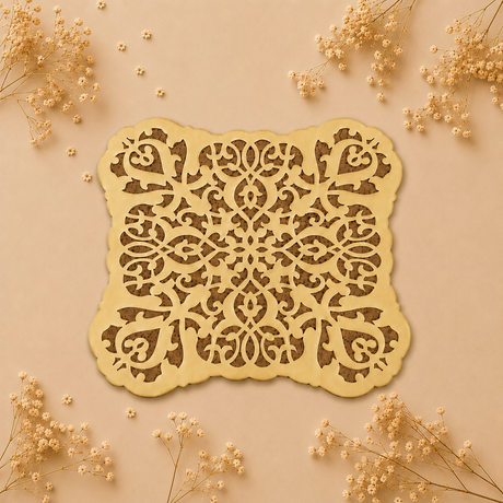Decorative laser-cut paper with intricate patterns on a beige background with dried flowers.