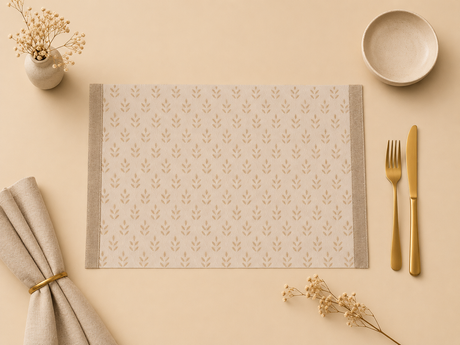 Patterned placemat with cutlery and decorative elements on a beige surface