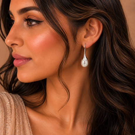 Close-up of a woman wearing a pearl earring with a soft focus background