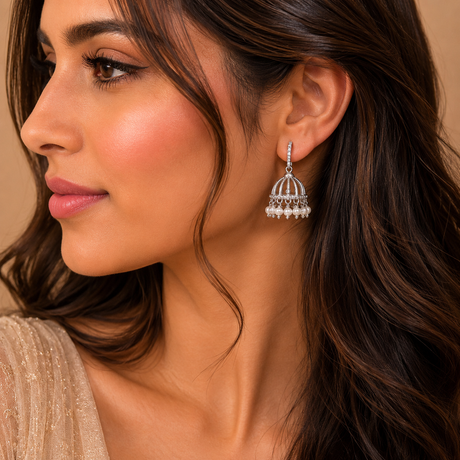 Close-up of a woman wearing a silver earring with a detailed design.