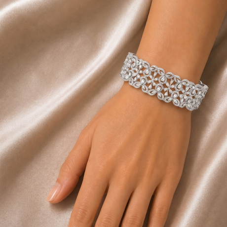 Silver bracelet on a hand against a satin background