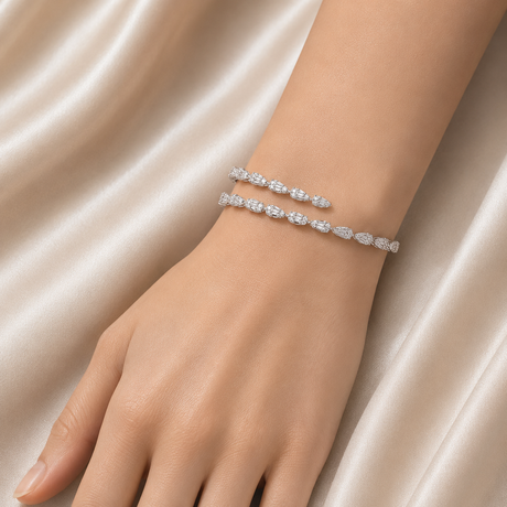 Silver bracelet on a wrist with a soft beige background