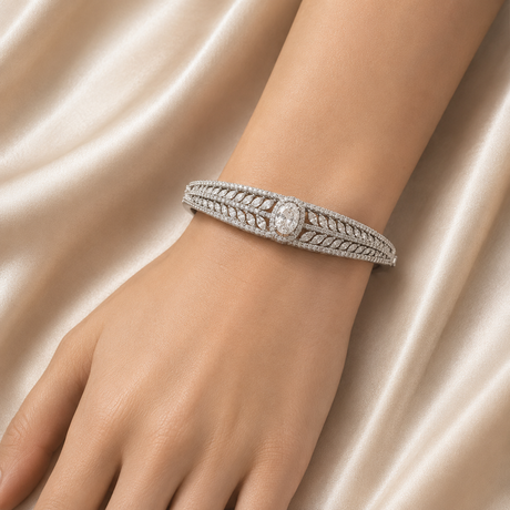 Silver bracelet with a diamond on a hand against a satin background