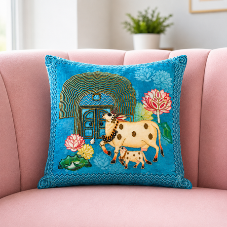 Decorative pillow with cow and floral design on a pink couch