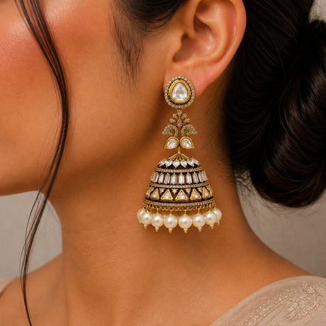 Close-up of a woman wearing a gold and pearl earring.