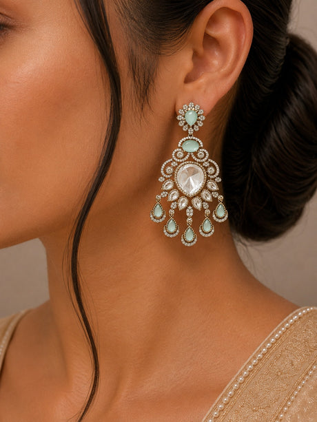 Close-up of a woman wearing a decorative earring with a neutral background