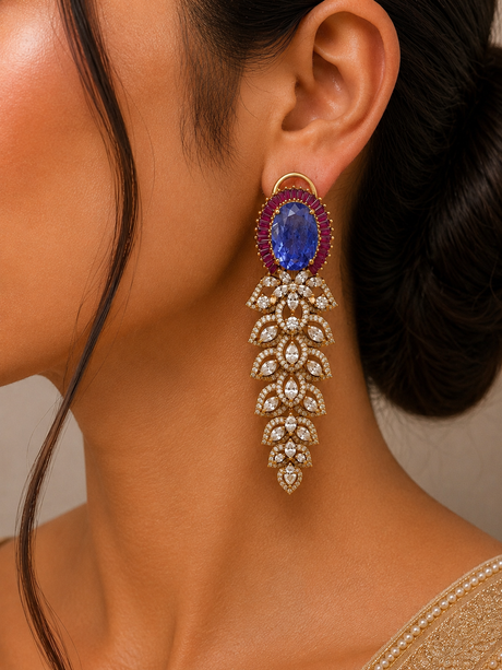 Close-up of a person wearing a decorative earring with a blue gemstone and gold accents.
