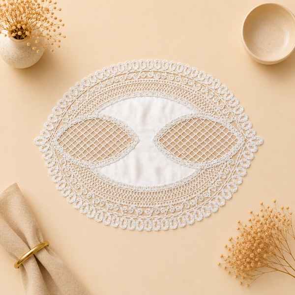 Decorative lace doily on a beige surface with a napkin and dried flowers.
