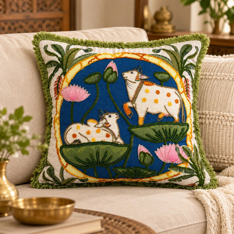 16x16 inch square hand embroidered cow and lotus cushion cover styled on a beige sofa.