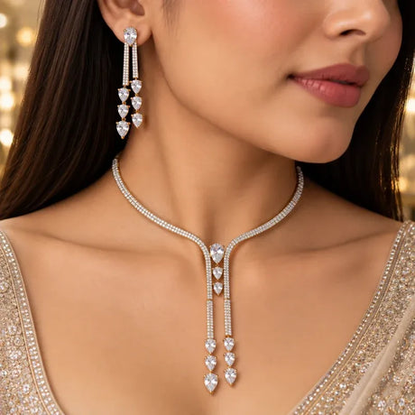 Two-tone American diamond CZ necklace and matching long drop earrings worn with occasion wear