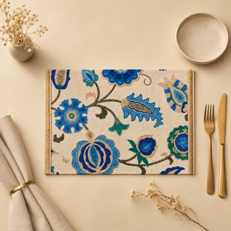 Floral patterned placemat with cutlery and napkins on a beige surface