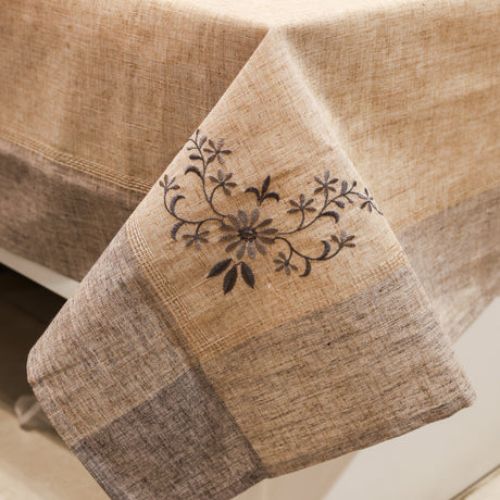 Textured fabric with floral embroidery on a neutral background